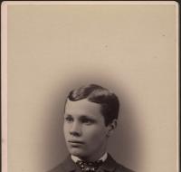 Young man wearing a coat with a bow tie