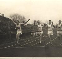 Postcard - Four men running across finish line