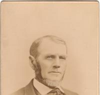 Bearded man wearing a coat with a vest and a bow tie